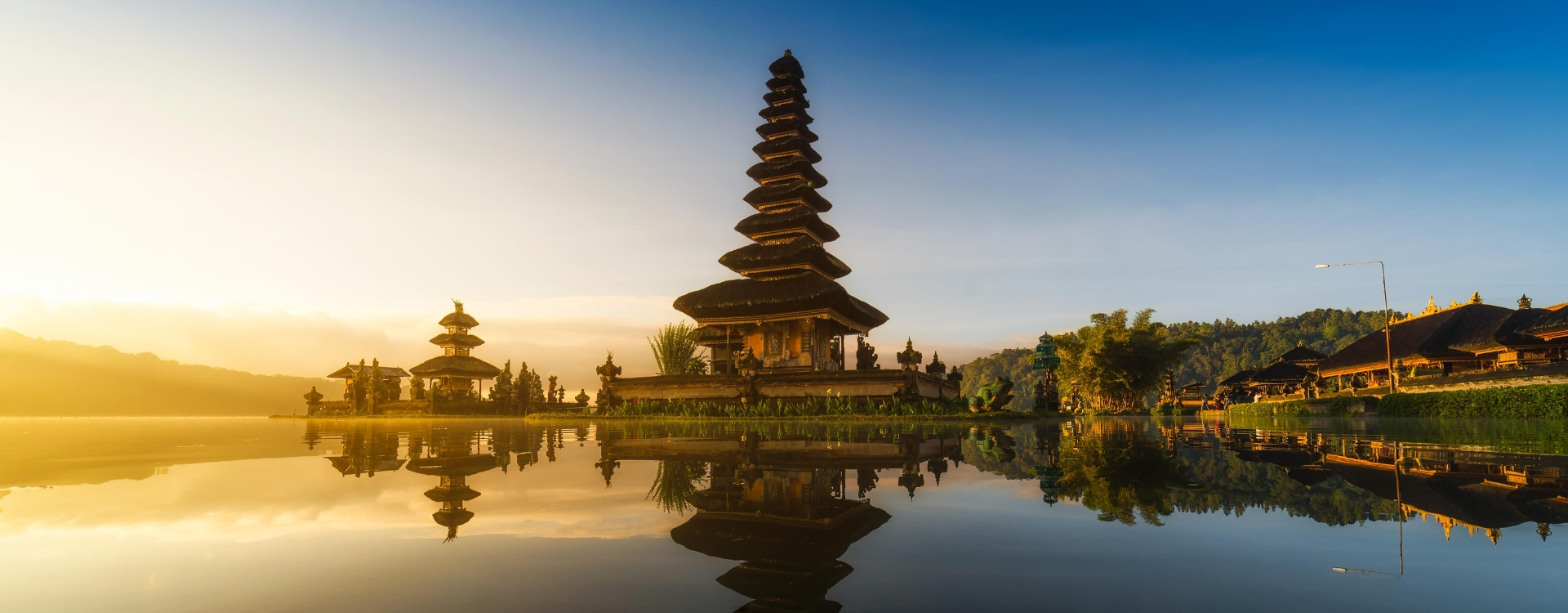 Pura Ulun Danu Bratan Temple reflecting on Lake Bratan at sunrise—a romantic Bali destination for couples